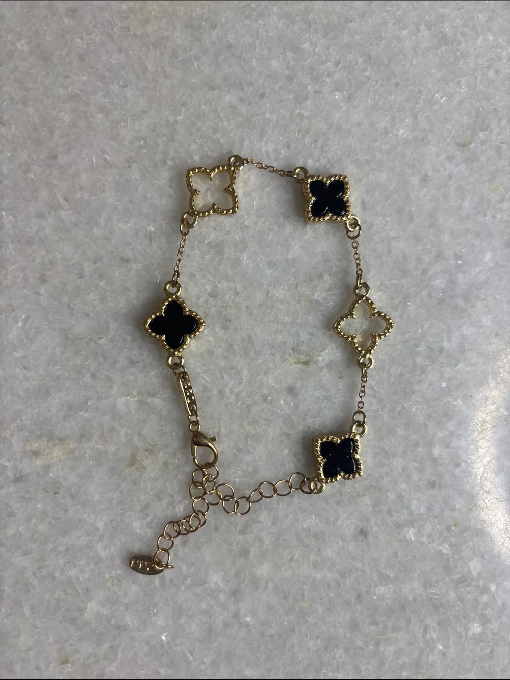 Gold-Tone Four-Leaf Clover Bracelet with Black and White Enamel